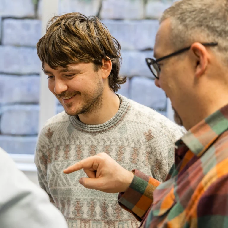 Ein Experte von Schweinberger Glasfaser Experte erläutert im Fachgespräch einem Kollegen oder Kunden wichtige Details zur technischen Planung einer Breitbandverbindung.